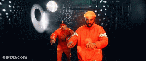 A Man In An Orange Jacket With The Letter P On It GIF
