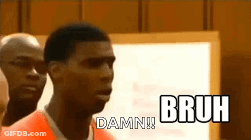 A Man In An Orange Prison Uniform Is Standing In Front Of A White Board And Says Bruh Damn . GIF