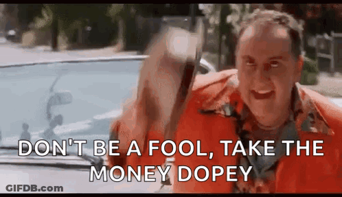 A Man In An Orange Shirt Is Driving A Car And Holding A Bag Of Money In His Hand . GIF