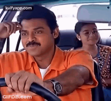 A Man In An Orange Shirt Is Driving A Car With A Woman Sitting In The Back Seat . GIF