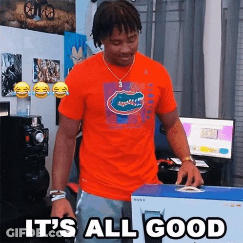 A Man In An Orange Shirt Is Holding A Box That Says It 'S All Good On It GIF