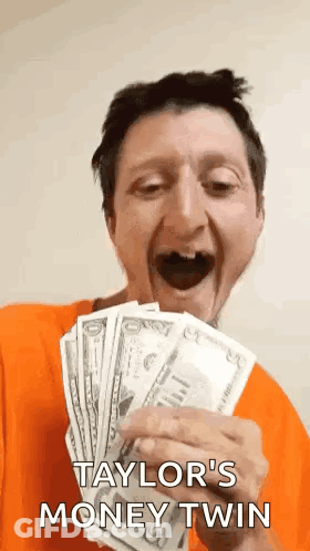 A Man In An Orange Shirt Is Holding A Bunch Of Money And Says Taylor 'S Money Twin . GIF