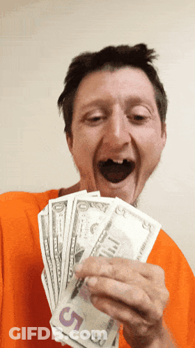 A Man In An Orange Shirt Is Holding A Stack Of 5 Dollar Bills GIF