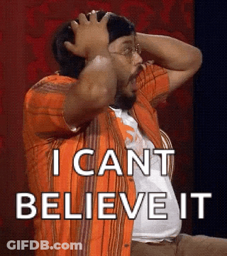 A Man In An Orange Shirt Is Holding His Head And Says I Can 'T Believe It . GIF