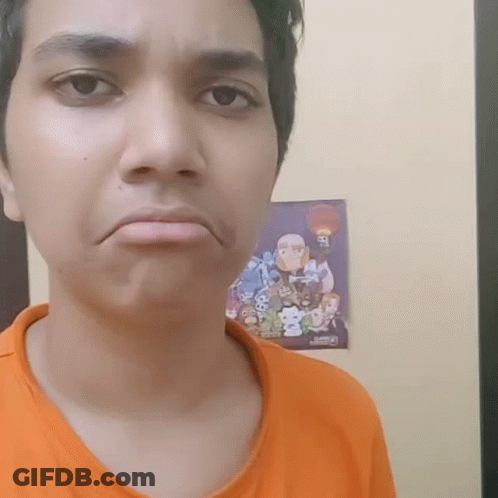 A Man In An Orange Shirt Is Making A Face In Front Of A Poster That Says Ben 10 GIF