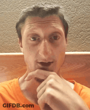 A Man In An Orange Shirt Is Making A Face GIF