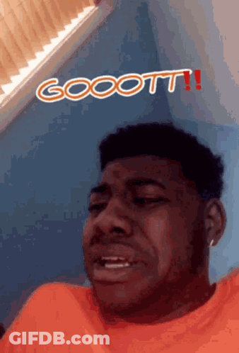 A Man In An Orange Shirt Is Making A Funny Face With The Words Goott Written Above Him GIF