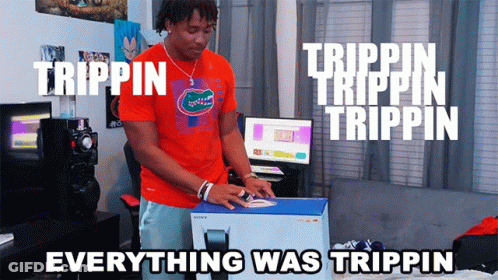 A Man In An Orange Shirt Is Opening A Box That Says Trippin On It GIF
