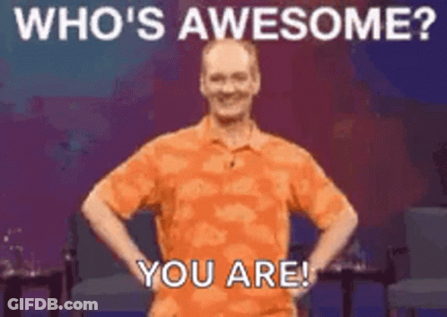 A Man In An Orange Shirt Is Standing With His Hands On His Hips And Says `` Who 'S Awesome ? You Are '' . GIF