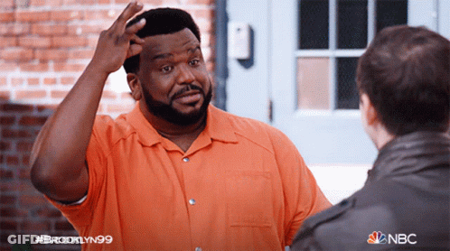 A Man In An Orange Shirt Is Talking To Another Man In A Brooklyn99 Advertisement GIF
