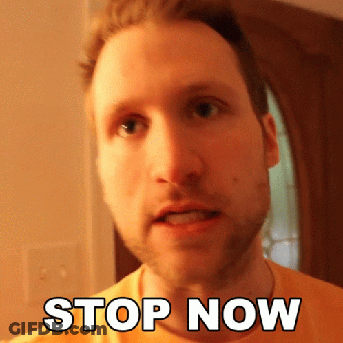 A Man In An Orange Shirt Says " Stop Now " In White Letters GIF