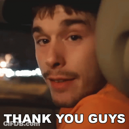 A Man In An Orange Shirt Says Thank You Guys In White Letters GIF
