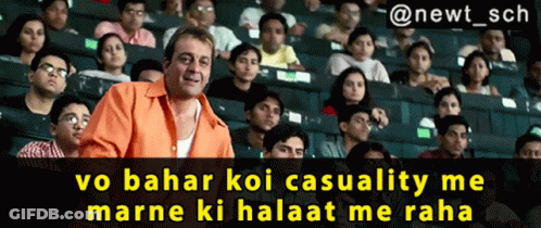 A Man In An Orange Shirt Stands In Front Of A Crowd Of People With The Caption " @Newt_sch GIF