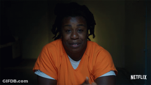 A Man In An Orange Shirt With Netflix Written On The Bottom Right GIF