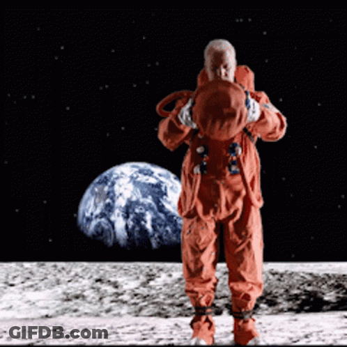 A Man In An Orange Space Suit Stands On The Moon In Front Of The Earth GIF