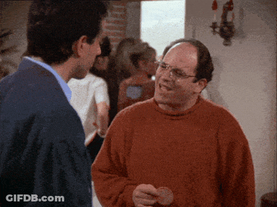 A Man In An Orange Sweater Is Talking To Another Man In A Blue Jacket GIF