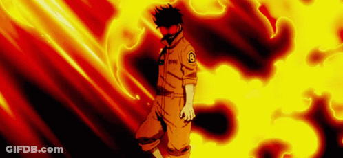 A Man In An Orange Uniform Is Standing In Front Of A Fire . GIF