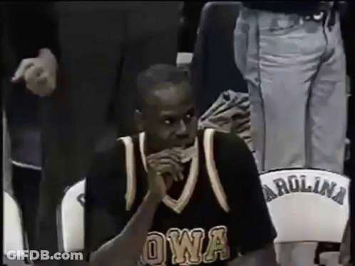 A Man In An Owa Jersey Sits In A Carolina Chair GIF