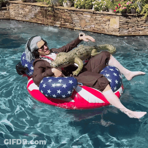 A Man In An Uncle Sam Costume Is Floating On An American Flag Raft In A Pool GIF