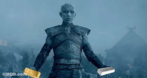 A Man In Armor Holds A Gold Bar And A Silver Bar In His Hands GIF