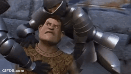 A Man In Armor Is Being Attacked By A Group Of Robots . GIF