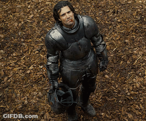 A Man In Armor Is Holding A Helmet And Smoking A Cigar GIF