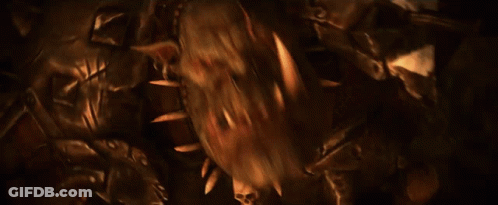 A Man In Armor Is Holding A Large Axe In His Right Hand GIF