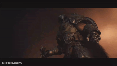 A Man In Armor Is Holding A Sword GIF