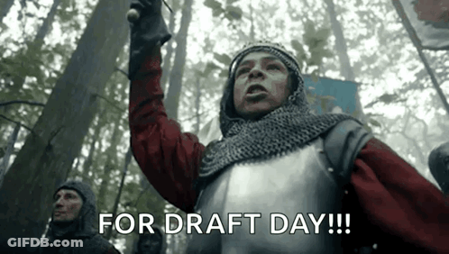 A Man In Armor Is Holding A Sword In A Forest And Says `` For Draft Day ! '' GIF