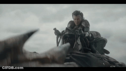 A Man In Armor Is Riding On The Back Of A Dragon .. GIF