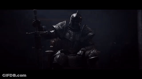 A Man In Armor Is Sitting On A Throne With A Sword GIF
