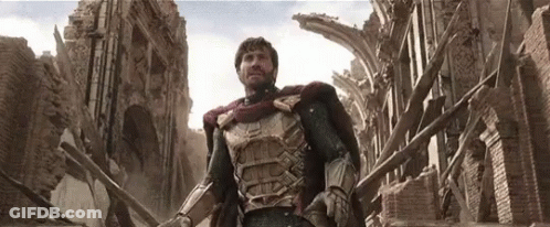 A Man In Armor Is Standing In Front Of A Destroyed Building GIF