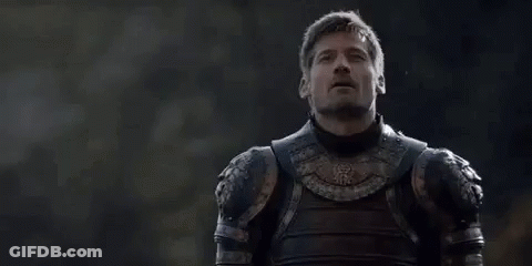 A Man In Armor Is Standing In Front Of A Forest Looking Up . GIF