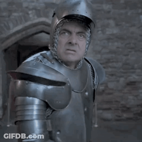 A Man In Armor Is Standing In Front Of A Window GIF