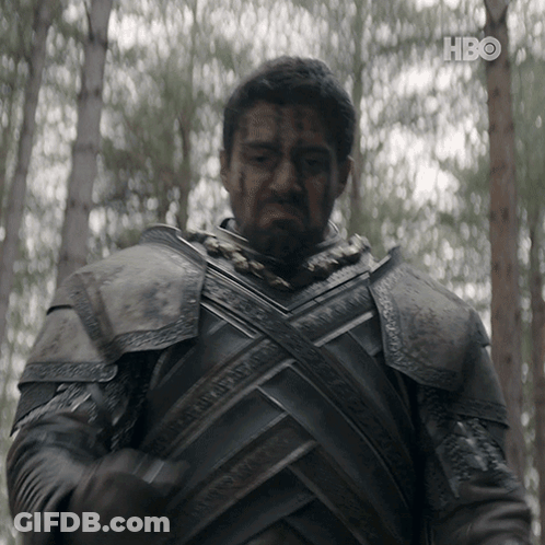 A Man In Armor Is Standing In The Woods With A Hbo Logo In The Background GIF