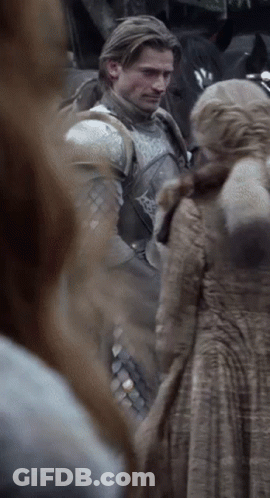 A Man In Armor Is Standing Next To A Woman GIF