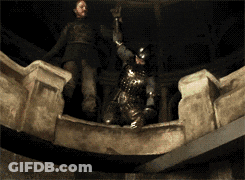 A Man In Armor Is Standing On A Ledge Holding A Sword GIF