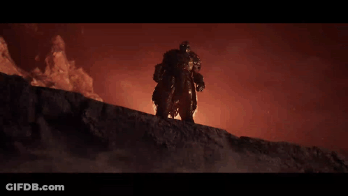 A Man In Armor Is Standing On Top Of A Rock GIF