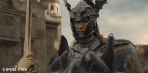 A Man In Armor Riding A Horse With A Sword In His Hand GIF