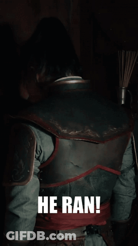 A Man In Armor Says He Ran In Front Of A Dark Background GIF