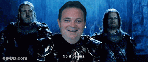 A Man In Armor Says So It Begins In Front Of Two Men GIF