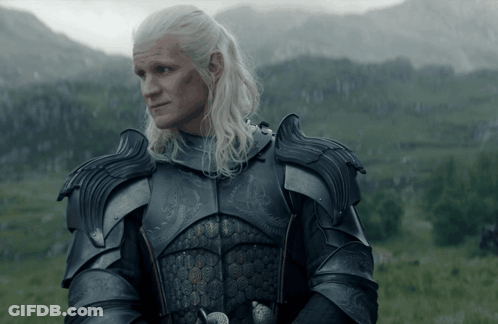 A Man In Armor Stands In A Grassy Field GIF