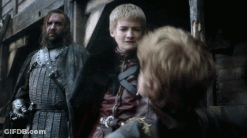 A Man In Armor Stands Next To A Young Boy In A Leather Jacket GIF