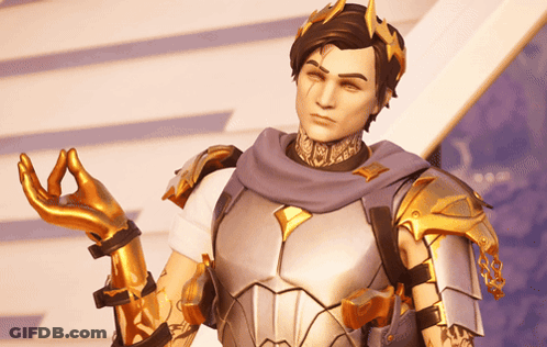 A Man In Armor With A Crown On His Head Is Making A Peace Sign GIF