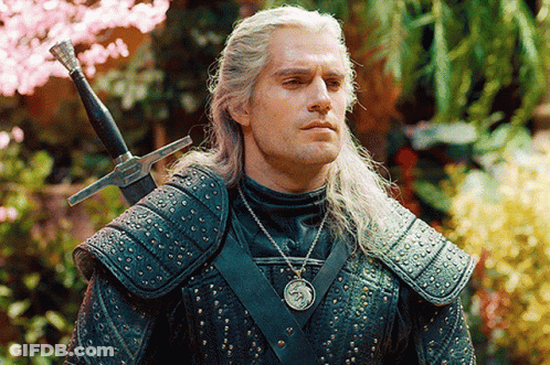 A Man In Armor With A Sword On His Shoulder GIF