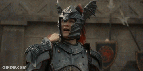 A Man In Armor With His Arms Outstretched Is Laughing GIF