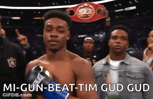 A Man In Boxing Gloves Is Holding A Boxing Championship Belt And Says " Mi-Gun-Beat-Tim Gud Gud " GIF