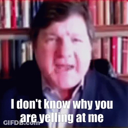 A Man In Front Of A Bookshelf Says I Don T Know Why You Are Yelling At Me GIF