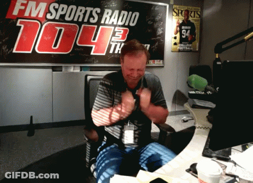 A Man In Front Of A Fm Sports Radio Sign GIF