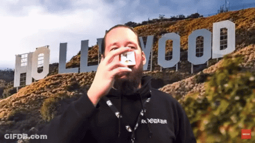 A Man In Front Of A Hollywood Sign GIF